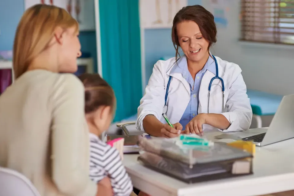 Nurse Practitioner Administering Exam to Young Pediatric Patient